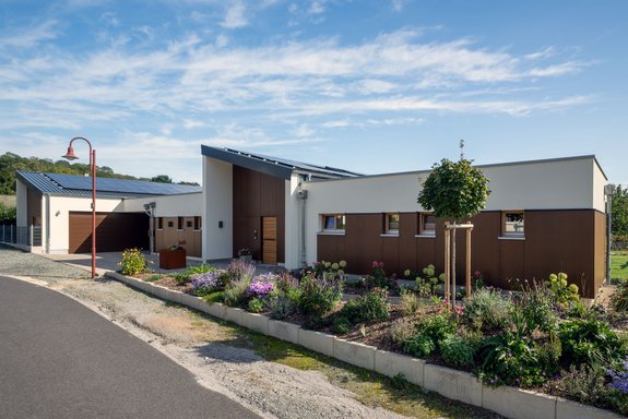 Bungalow mit Putzfassade, Walmdach und Naturpool