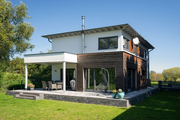 Einfamilienhaus mit Flachdachcarport und Holzfassaden Akzenten